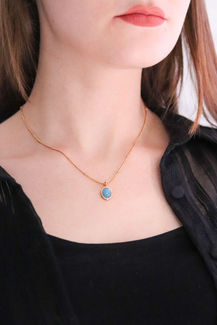 Gold Toned Snake Necklace with Blue Stone Pendant